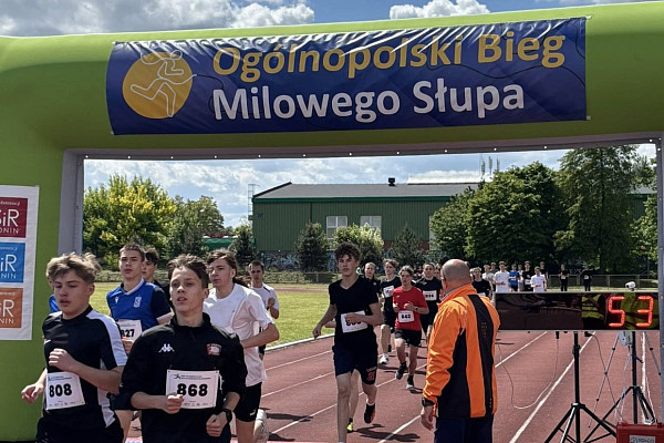 Zawodnicy podczas Dziecięco - młodzieżowego Biegu Milowego Słupa w Koninie. W tle bieżnia i brama startowa z napisem Ogólnopolski Bieg Milowego Słupa.